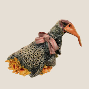 Ceramic bird with pink bow art.